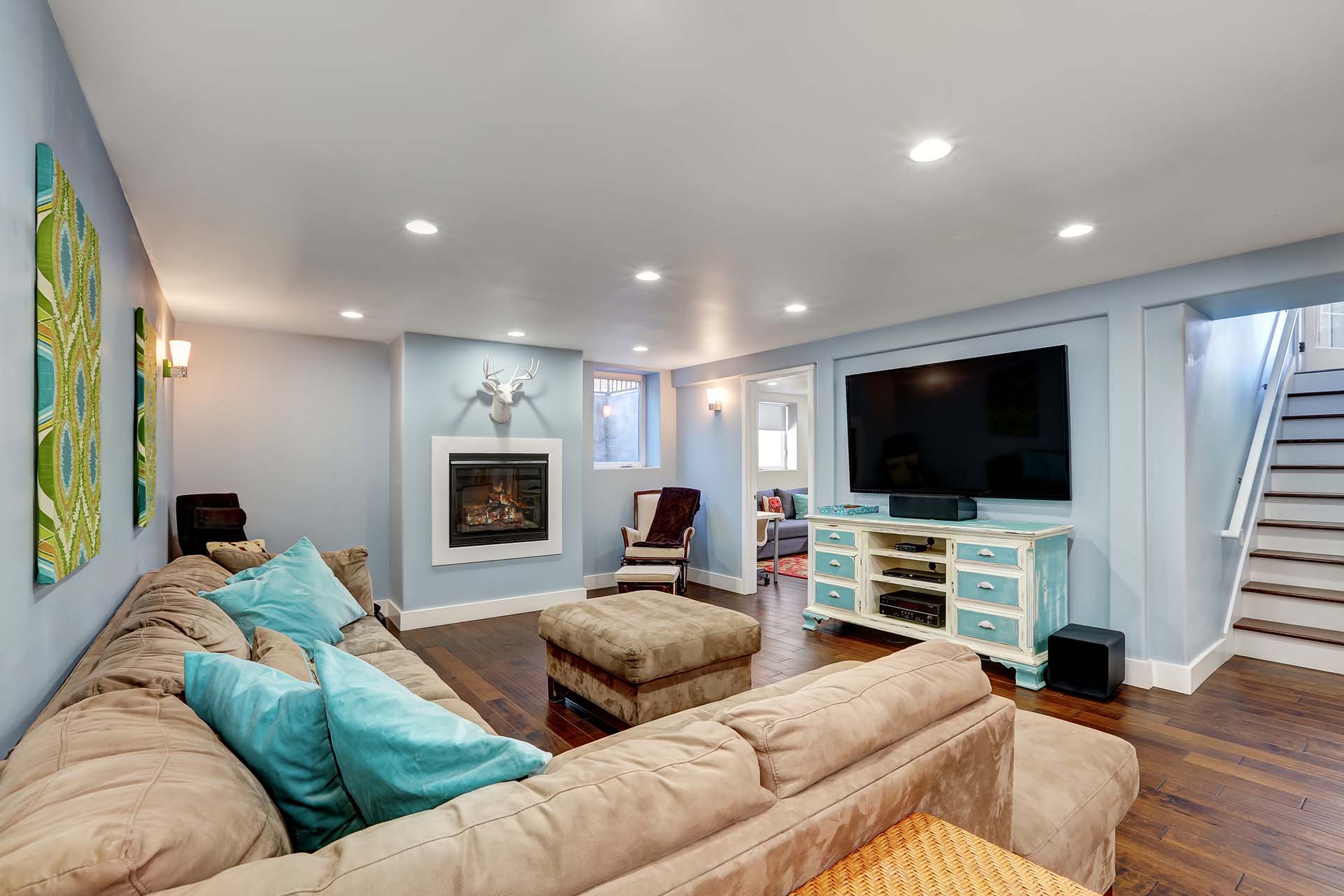 Pastel blue walls in basement living room interior.