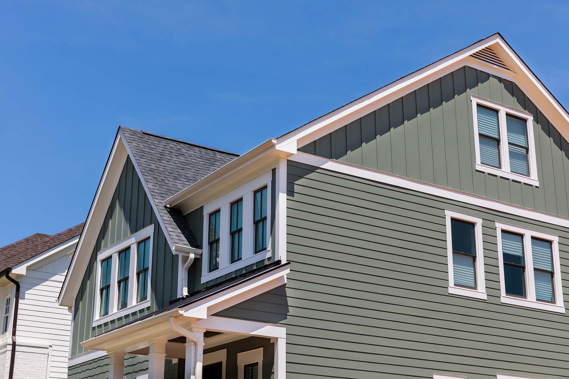 new home construction with green siding