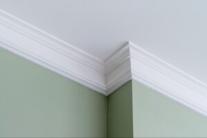 A close-up view of trim on a wall next to a ceiling.